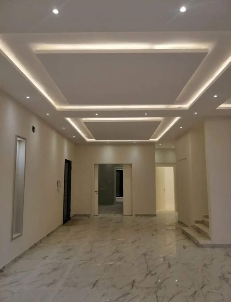 Gypsum false ceiling in a hall with a central tray Gypsum false ceiling in a hall with a central tray