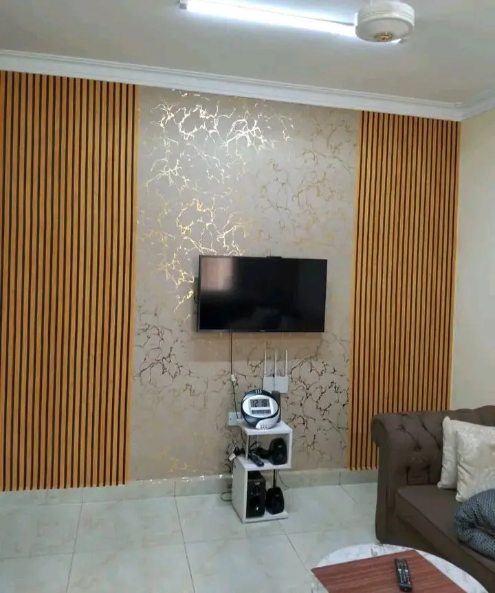 Fluted WPC panel behind a bed headboard